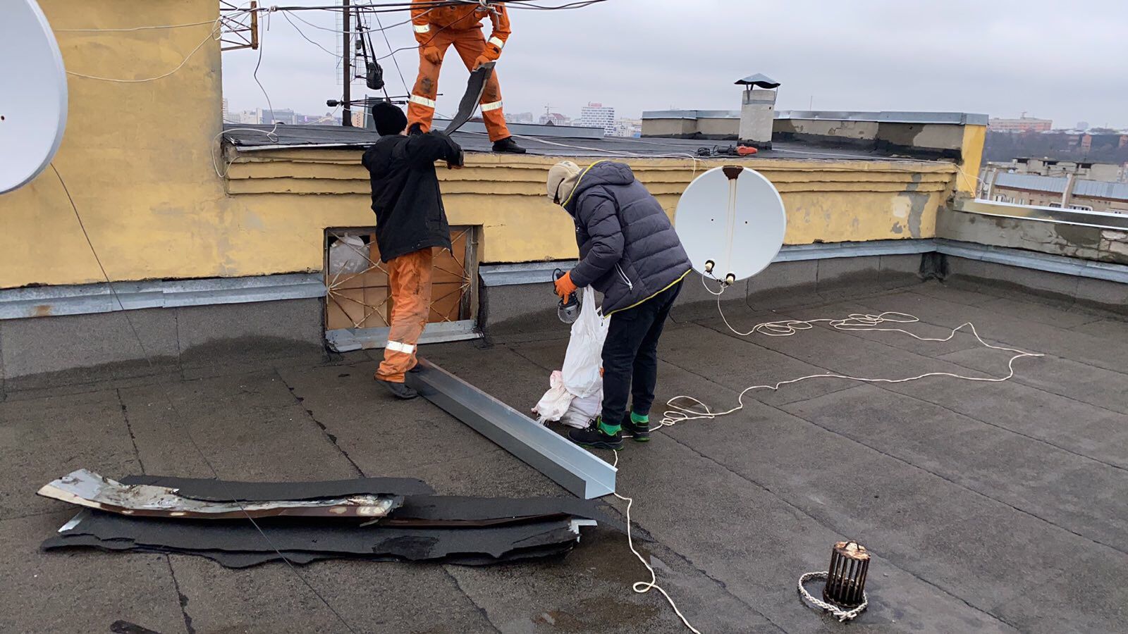 Відновлюють дах будинку на Основі комунальники Харкова